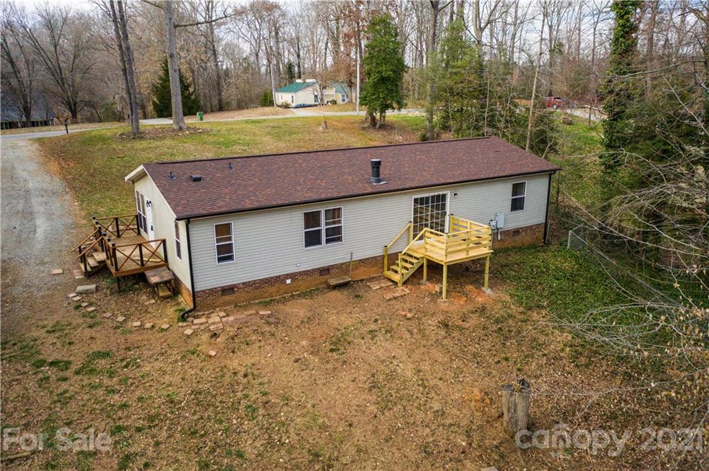 404 Rutledge Road Mount Holly, NC 28120 - Photo 1 of 40 a backyard of a house with table and chairs