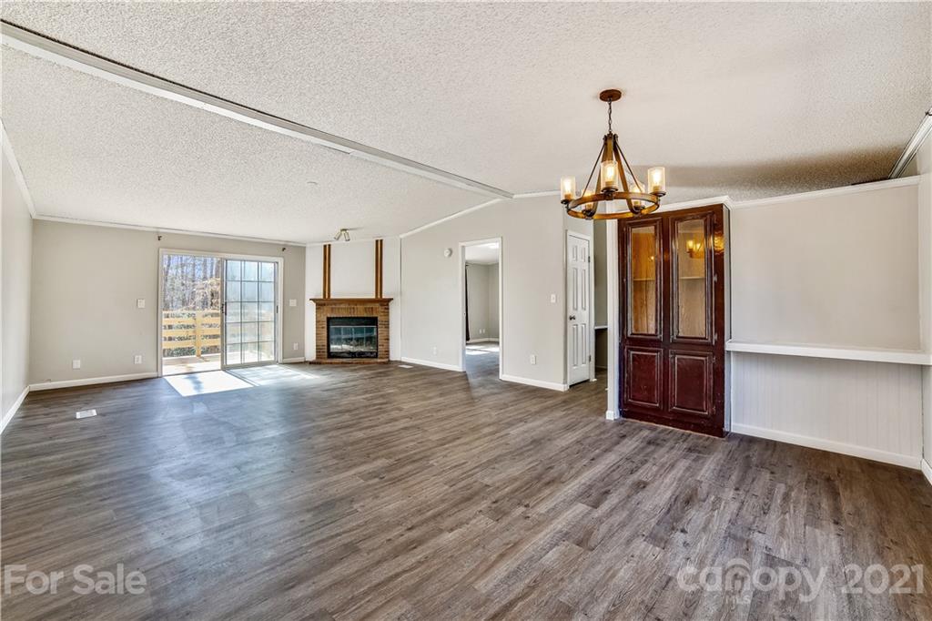404 Rutledge Road Mount Holly, NC 28120 - Photo 14 of 40 a view of a livingroom with wooden floor a ceiling fan and window