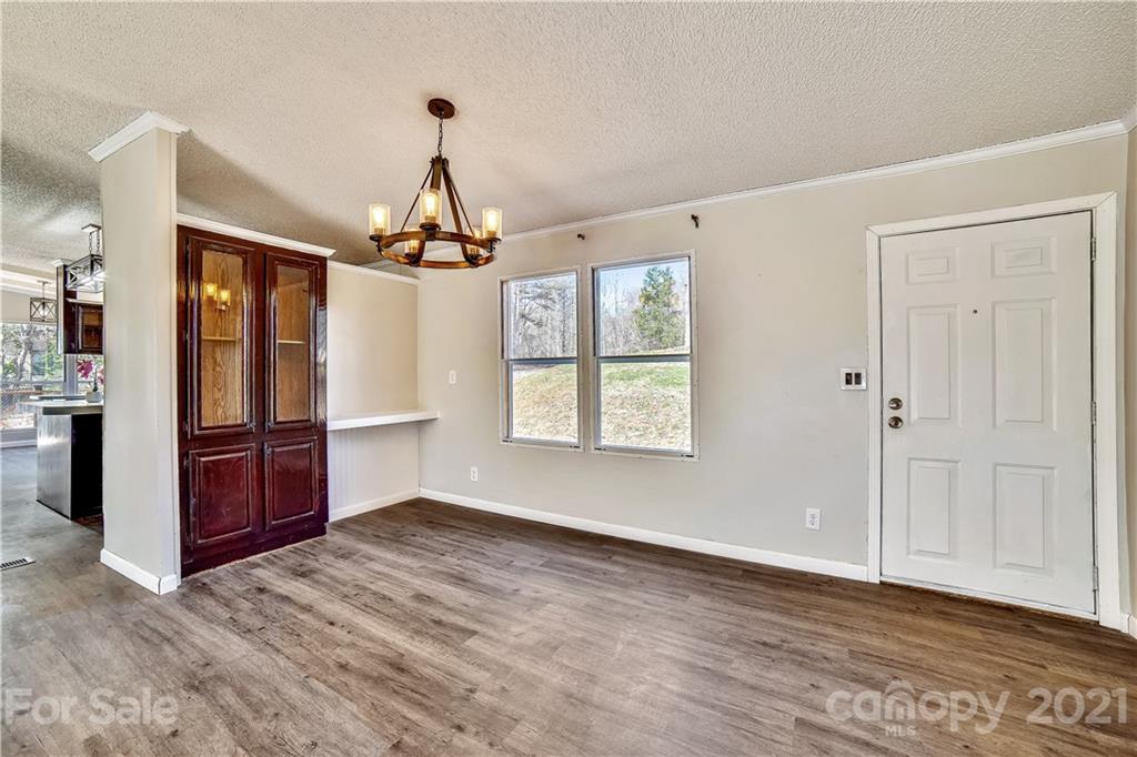 404 Rutledge Road Mount Holly, NC 28120 - Photo 17 of 40 a view of a room with window wooden floor and chandelier