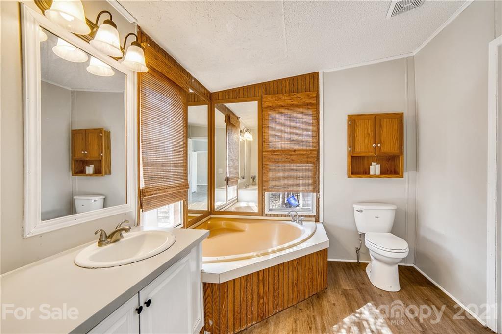404 Rutledge Road Mount Holly, NC 28120 - Photo 21 of 40 a bathroom with a granite countertop sink and a large mirror