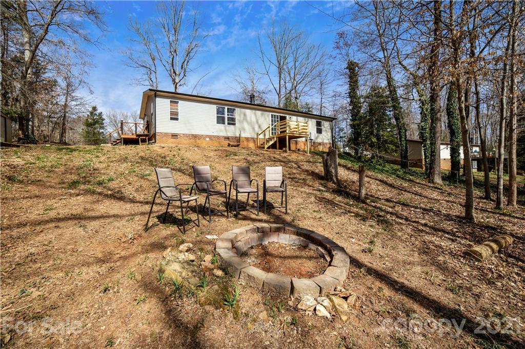404 Rutledge Road Mount Holly, NC 28120 - Photo 34 of 40 a backyard of a house with large trees