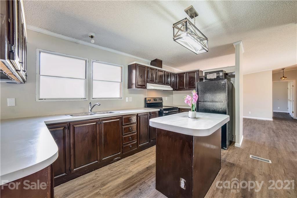 404 Rutledge Road Mount Holly, NC 28120 - Photo 8 of 40 a kitchen with a sink stove and cabinets