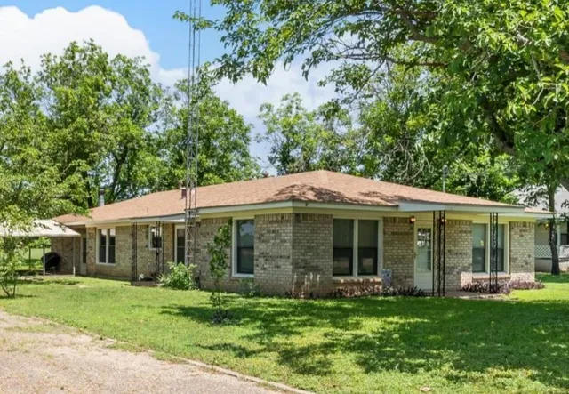 a view of a house with a yard and sitting area