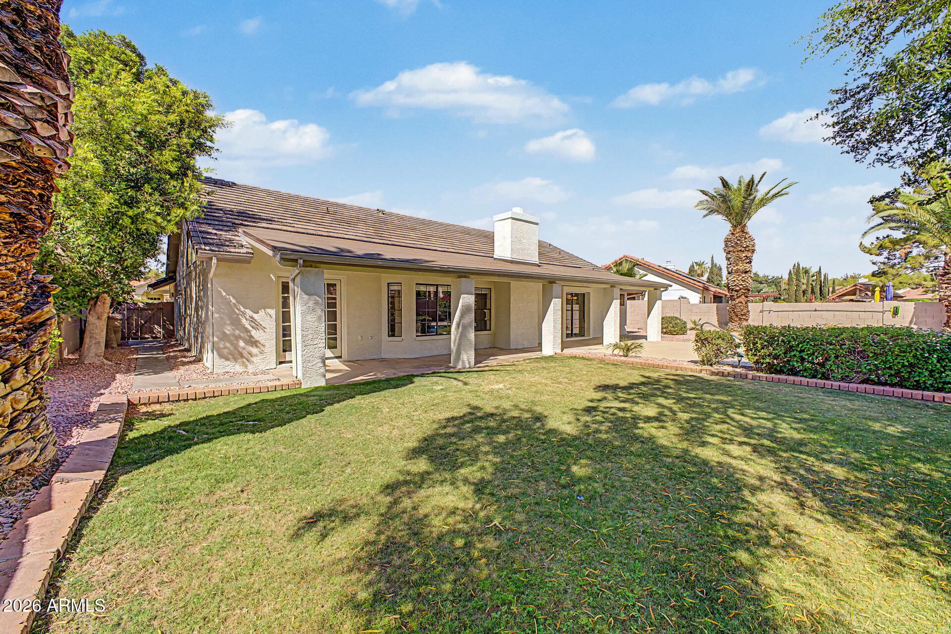 6725 West Utopia Road Glendale, AZ 85308 - Photo 22 of 27 a front view of a house with a garden