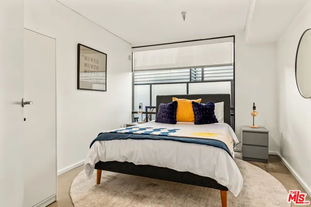 a bedroom with a bed and window