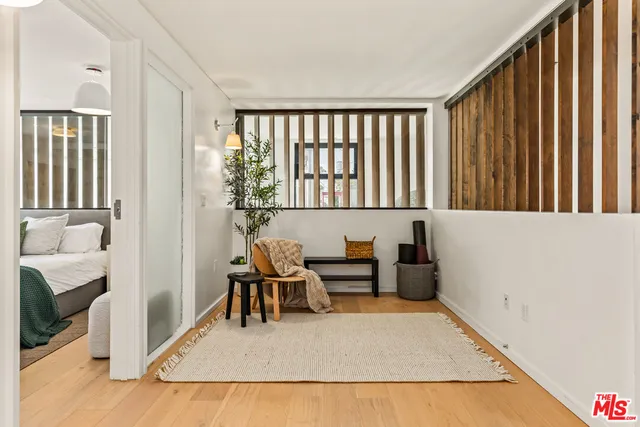 a living room with furniture rug and wooden floor