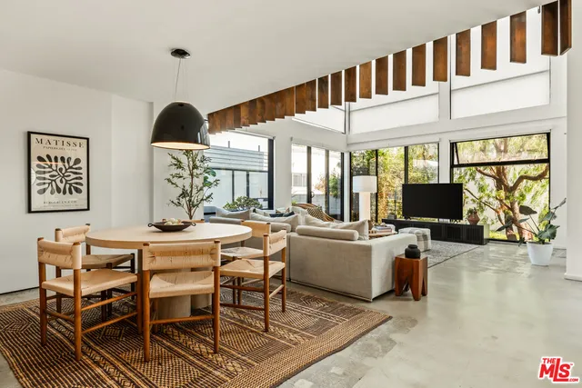 a view of a livingroom with furniture window and wooden floor