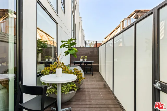 a balcony view with a table and chairs
