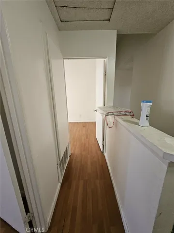 a view of an empty room and wooden floor