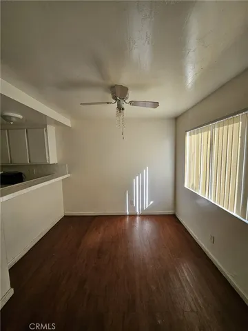 a view of a kitchen with center island and stainless steel appliances