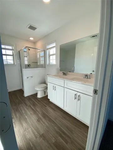 a spacious bathroom with a toilet sink and mirror