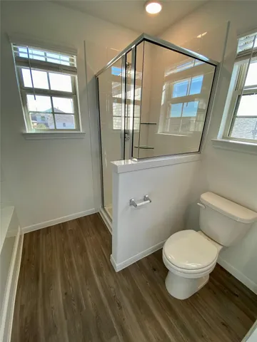 a bathroom with a toilet and a window