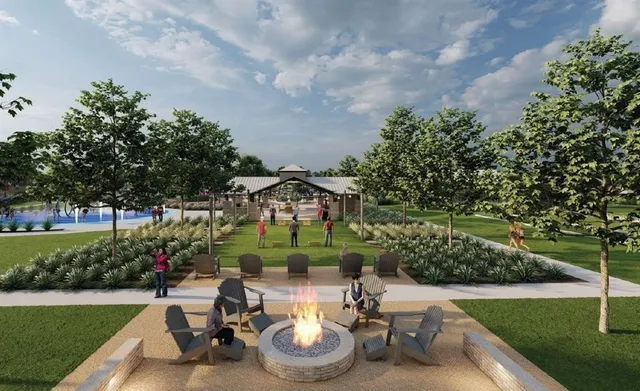 a view of a chair and table in backyard of the house