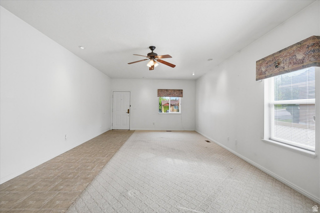 560 East 700 North Logan, UT 84321 - Photo 3 of 32 Spacious living area featuring a ceiling fan, recessed lighting, and multiple windows for natural light