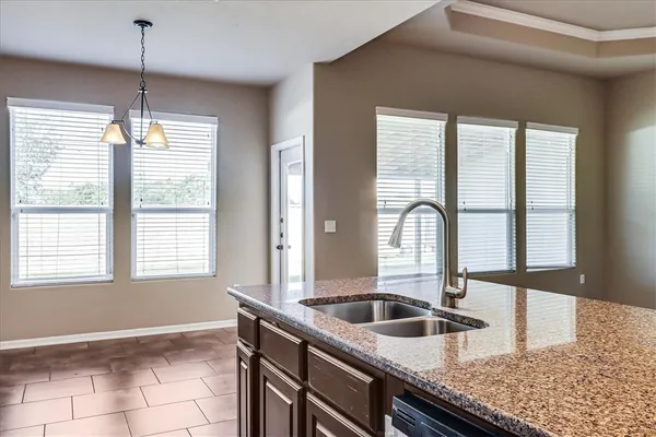 a kitchen with granite countertop a sink and a window