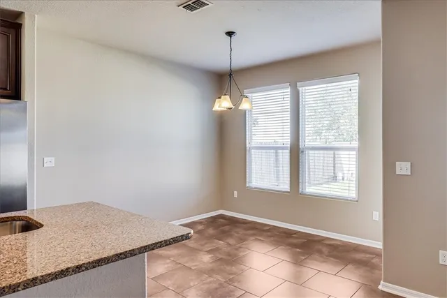 a view of a kitchen with a dishwasher cabinets and a window