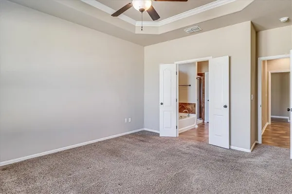 an empty room with a ceiling fan and a window