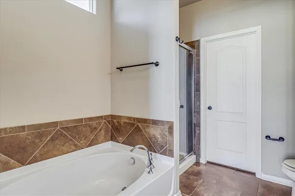a bathroom with a bathtub and shower