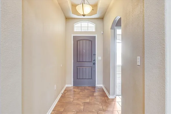 a view of a livingroom with wooden floor and front door