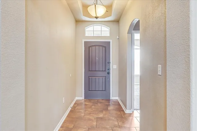 a view of a livingroom with wooden floor and front door