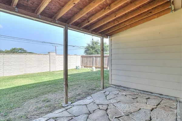 a view of a backyard with plants and a backyard
