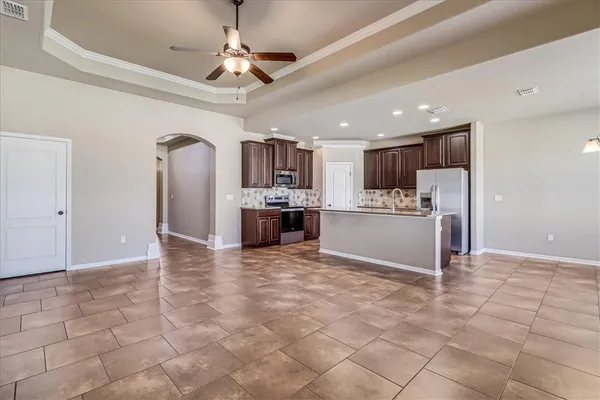 a view of a kitchen with a sink and stainless steel appliances