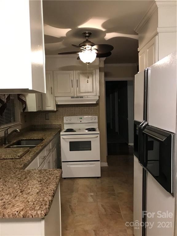 10441 Rockwood Road Charlotte, NC 28215 - Photo 13 of 45 a kitchen with a stove and a refrigerator
