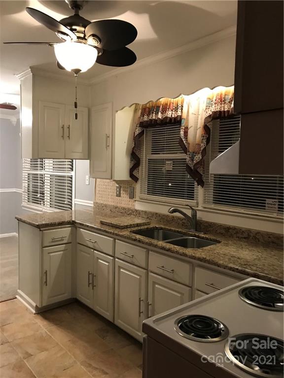 10441 Rockwood Road Charlotte, NC 28215 - Photo 15 of 45 a kitchen with a sink and cabinets