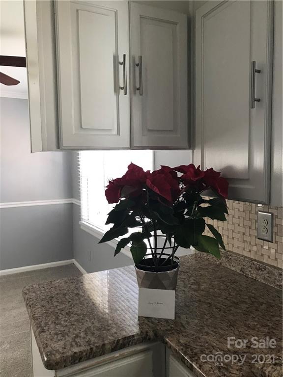 10441 Rockwood Road Charlotte, NC 28215 - Photo 16 of 45 a vase of flowers sitting on a table