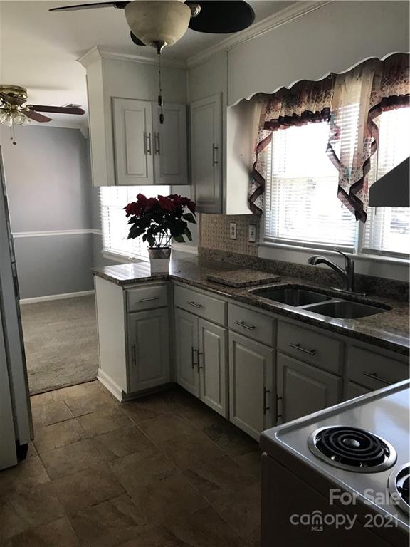 10441 Rockwood Road Charlotte, NC 28215 - Photo 17 of 45 a kitchen with stainless steel appliances a sink a stove and a refrigerator