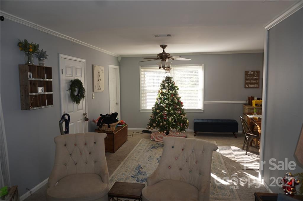 10441 Rockwood Road Charlotte, NC 28215 - Photo 26 of 45 a living room with furniture and a chandelier