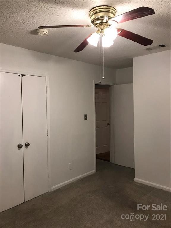 10441 Rockwood Road Charlotte, NC 28215 - Photo 28 of 45 a view of a hallway with a chandelier