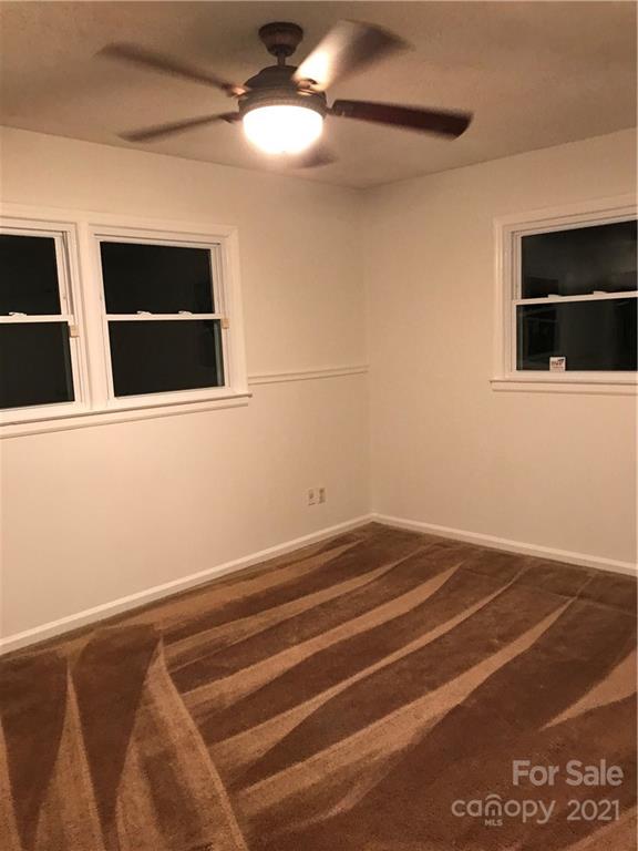 10441 Rockwood Road Charlotte, NC 28215 - Photo 29 of 45 a view of a livingroom with an empty space & a ceiling fan