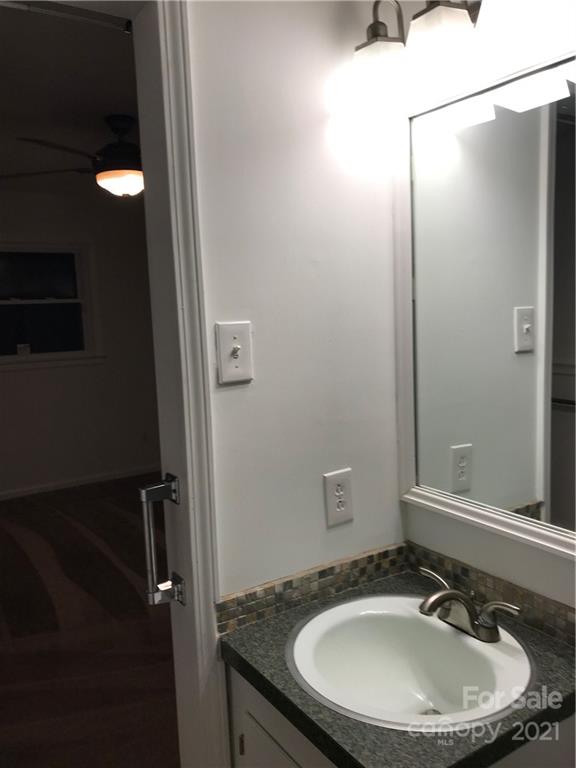 10441 Rockwood Road Charlotte, NC 28215 - Photo 32 of 45 a bathroom with a sink and a mirror