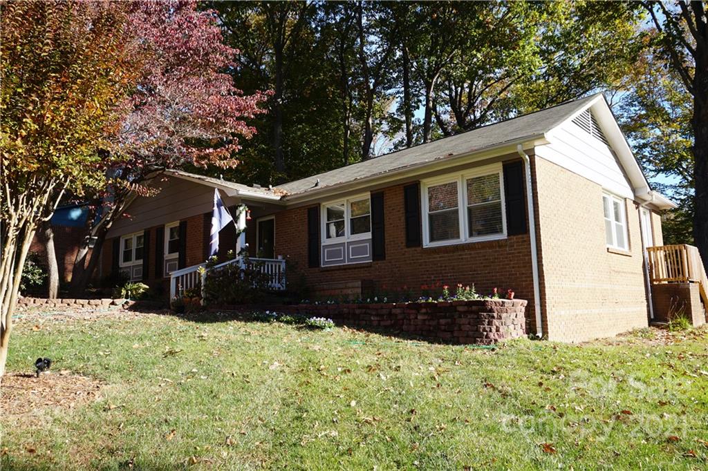 10441 Rockwood Road Charlotte, NC 28215 - Photo 6 of 45 a front view of a house with a yard covered in snow