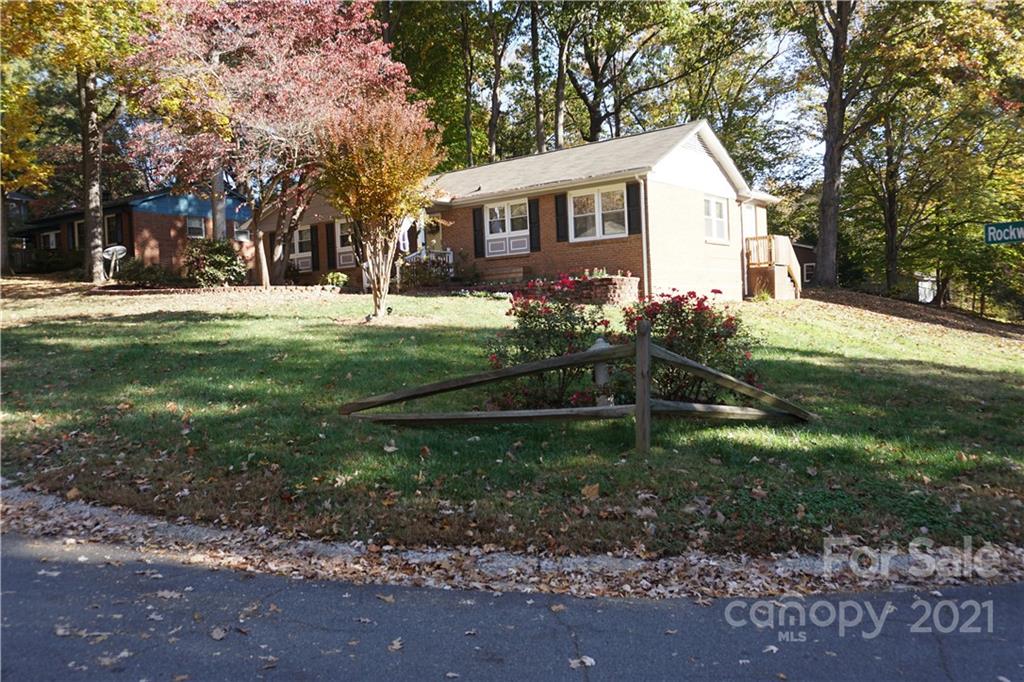 10441 Rockwood Road Charlotte, NC 28215 - Photo 8 of 45 a view of house in front of a big yard with large trees