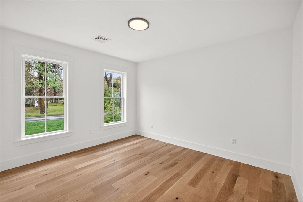 132 Great Western Road Harwich, MA 02645 - Photo 29 of 42 an empty room with wooden floor and windows