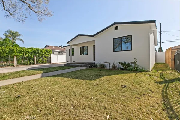 a view of a house with backyard and sitting area