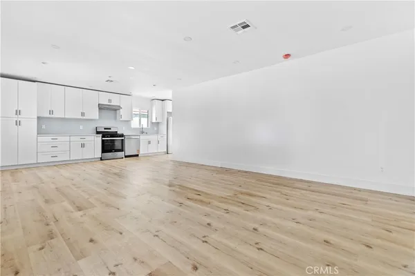 a view of kitchen and empty room