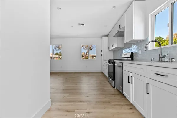 a kitchen with granite countertop a sink and wooden cabinets