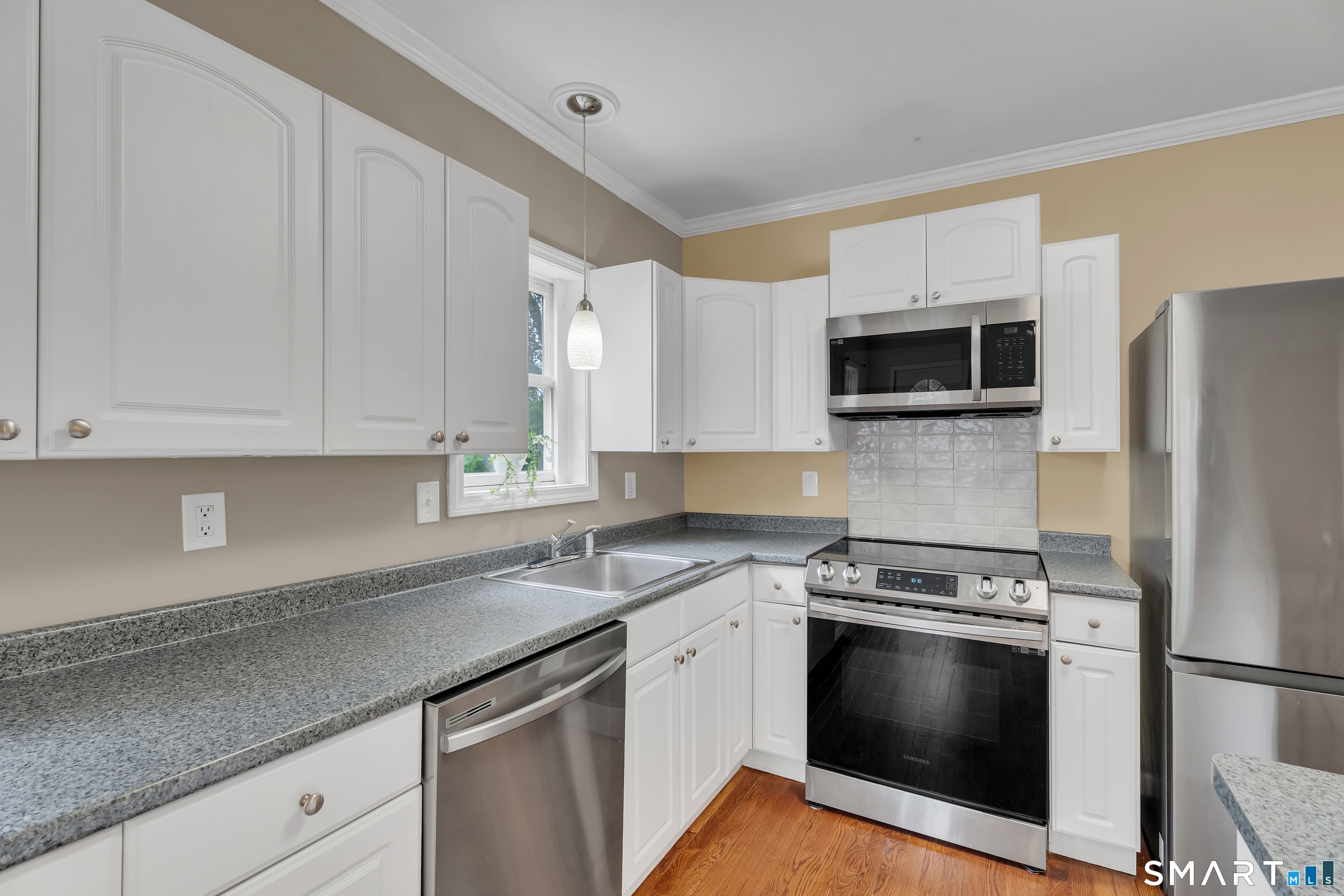 75 Summit Street Norwich, CT 06360 - Photo 21 of 40 a kitchen with granite countertop a sink stove and refrigerator