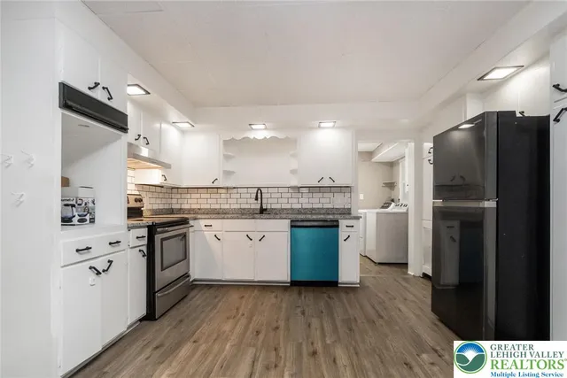 a view of a kitchen with a stove cabinets and a wooden floor