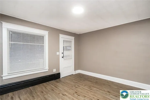 a view of an entryway with wooden floor