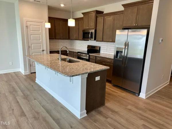 a kitchen with a sink stove and refrigerator