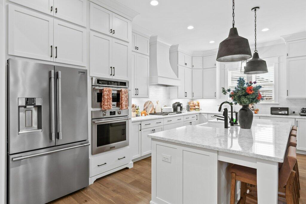 34 Caymus Cove Freeport, FL 32439 - Photo 14 of 42 a kitchen with kitchen island granite countertop appliances cabinets and a counter space
