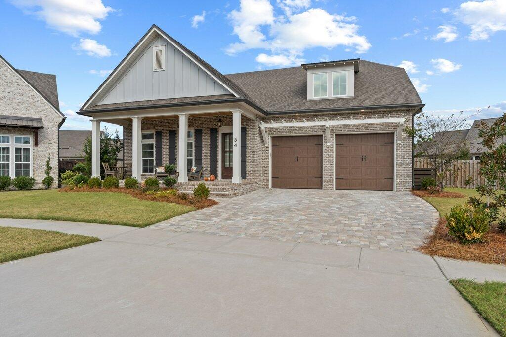 34 Caymus Cove Freeport, FL 32439 - Photo 2 of 42 a front view of a house with a yard and garage