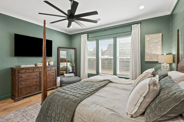 a bedroom with a bed and a flat screen tv