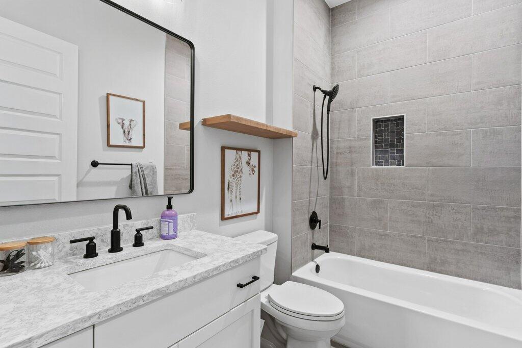 34 Caymus Cove Freeport, FL 32439 - Photo 27 of 42 a bathroom with a granite countertop sink a toilet and shower