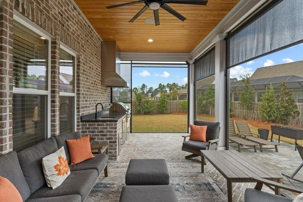 34 Caymus Cove Freeport, FL 32439 - Photo 37 of 42 a outdoor space with patio the couches and a dining table with garden view