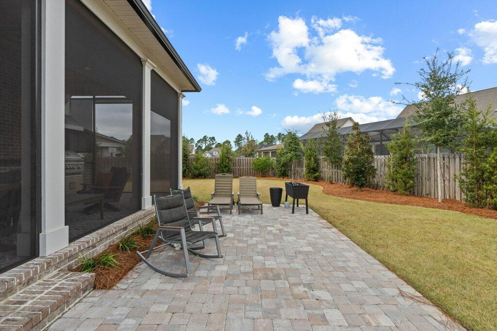34 Caymus Cove Freeport, FL 32439 - Photo 39 of 42 a view of a patio with table and chairs and potted plants